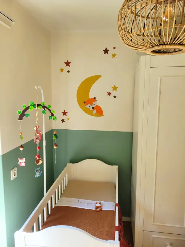 Mintgroene babykamer met okergele maan behangsticker met slapend vosje.